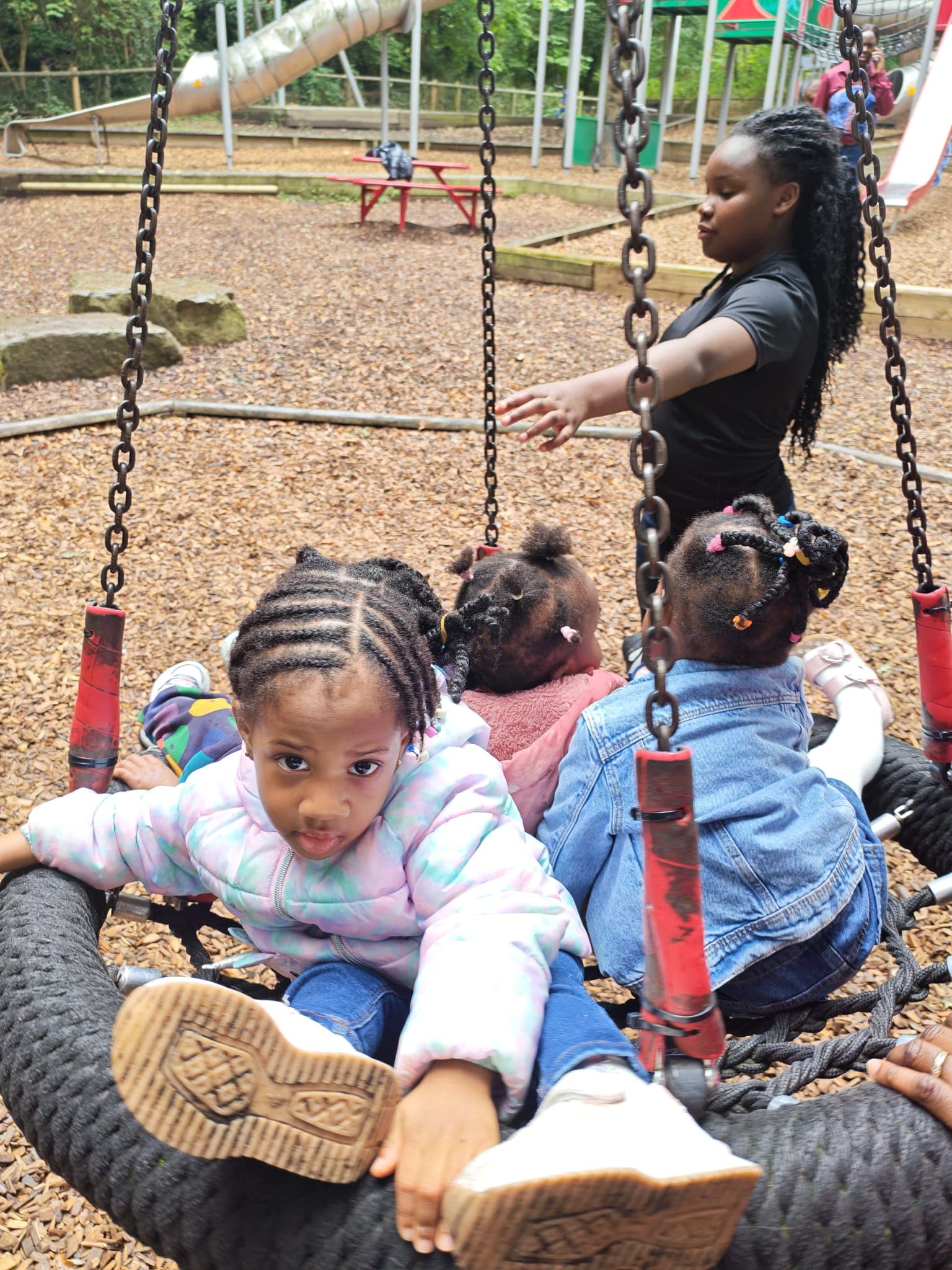Children playing together at an outdoor playground outing